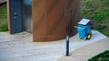 A park worker\'s cleaning trolley next to an elevator