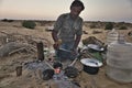 Parkash, the camel keeper from the Thar Desert Great Indian Desert in Rajasthan, is preparing dinner.