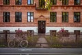 parked bicycle near wooden fence in front of building