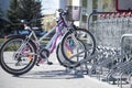 Parked bikes in a parcking rack in front of supermarket