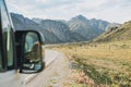 Parked car on auto road against beautiful mountain landscape, Chemalsky tract, Altai