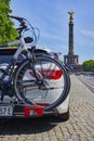 Parked car with a bike carrier attached to the stern and bicycles mounted on it. In the background you see the Berlin Siegessaeule Royalty Free Stock Photo