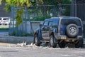 Parked Car and Fallen Debris from Abandoned Building