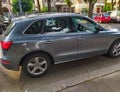 A parked car has been broken into: the front right window is reduced to tiny splinters, some are on the pavement, others scattered Royalty Free Stock Photo