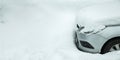 a parked car near a snowdrift covered with a pile of snow. Royalty Free Stock Photo