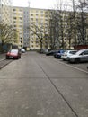 Parked cars in front of a yellowish high rise building in Berlin Germany