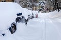Parked cars after heavy snowfall covered in snow completely