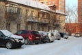 Parked cars near historic high-rise buildings in Novosibirsk narymskaya street in winter lack of Parking spaces