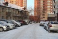 Parked cars near historic high-rise buildings in Novosibirsk narymskaya street in winter lack of Parking spaces