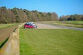 Parked cars seen near a race course on a clear, sunny day. Royalty Free Stock Photo