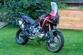 Parked CRF1000L Honda Africa Twin adventure bike in a green garden