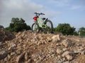 Parked cycle by innocent boy on rock Royalty Free Stock Photo