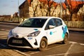 Parked EasyShare Toyota Yaris rental car on a parking place in the city center. Vehicle is a