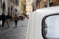 A parked Fiat 500 in the streets of Rome, a nun walking on the background. Royalty Free Stock Photo