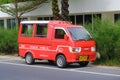 Parked red hijet pickup truck converted to carry passengers in the back