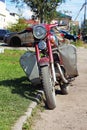 Parked at the lawn old red motorcycle Royalty Free Stock Photo