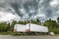 Parked semi-truck trailers on a dirt road in Alaska Royalty Free Stock Photo