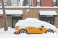 Parked New York City Yellow Taxi Cab Van Covered with Snow during a Massive Snowstorm in Astoria Queens