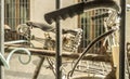 Parked vintage bicycles chained with padlock to window grille house