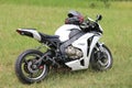 Parked white Honda CBR1000RR motorbike on green grass