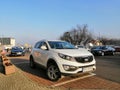 Parked white new Kia car on a parking spot in Poznan, Poland.