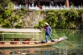 Parked wooden tourist boat on the Tuojiang River in Phoenix Ancient Town