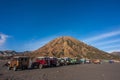 Parked 4x4 Jeeps on a desert with mount batok on the background Royalty Free Stock Photo