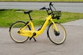 Parked yellow rent-a-bike near sidewalk. ecological transport for recreation