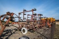 Parking agricultural machinery and harvest. rows of plows, cultivators, bodies Royalty Free Stock Photo