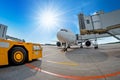 Parking at the airport, airplane at the teletrap. Aerodrome tractor is ready for towing and departure of the aircraft. Against the