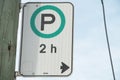 parking allowed for 2 hours h white green black vertical rectangle sign left 61 p 17