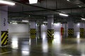 Parking area in the basement, white columns with a striped base, empty parking Royalty Free Stock Photo