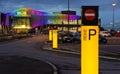 Parking area and illuminated front of the retail park Shopping City South