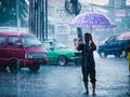 A parking attendant keeps working even though it's raining