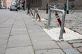 Parking barrier at parking place along the street in the city, cars and bicycles parked Royalty Free Stock Photo