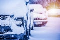 Parking cars covered with snow. Winter car; Snow; Blizzard. Poor visibility on the road.