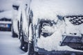 Parking cars covered with snow. Winter car; Snow; Blizzard. Poor visibility on the road. Royalty Free Stock Photo
