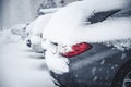 Parking cars covered with snow. Winter car; Snow; Blizzard. Poor visibility on the road. Royalty Free Stock Photo