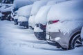 Parking cars covered with snow. Winter car; Snow; Blizzard. Poor visibility on the road. Royalty Free Stock Photo