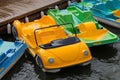 Parking of colorful water bicycles on a river.