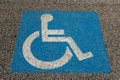 disabled parking symbol, symbol printed on the asphalt, parking reserved for disabled cars and their companions. Royalty Free Stock Photo