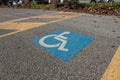 disabled parking symbol, symbol printed on the asphalt, parking reserved for disabled cars and their companions. Royalty Free Stock Photo