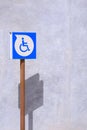 Parking disabled wheelchair sign on loft concrete wall outside of building in vertical frame