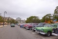 Parking full of classic American cars on a street in Cuba