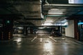 Parking Garage, Illuminated Underground Car Park Lots under modern Mall with Vehicles