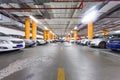 Parking garage, underground interior with a few parked cars