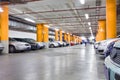 Parking garage, underground interior with a few parked cars