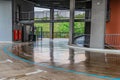 Parking garage, underground interior with a few parked cars. Neon light in bright industrial building. Royalty Free Stock Photo