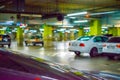 Parking lot cars blurred. Car lot parking space in underground city garage. Empty road asphalt background in soft focus. Royalty Free Stock Photo