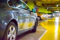 Parking lot cars blurred. Car lot parking space in underground city garage. Empty road asphalt background in soft focus. Royalty Free Stock Photo